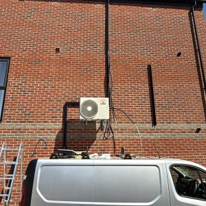 BDS Services Ltd installing residential air conditioning unit on brick wall at domestic property in Reading UK