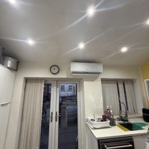 Sleek wall-mounted air conditioning unit installed in a modern new-build living room in Birmingham