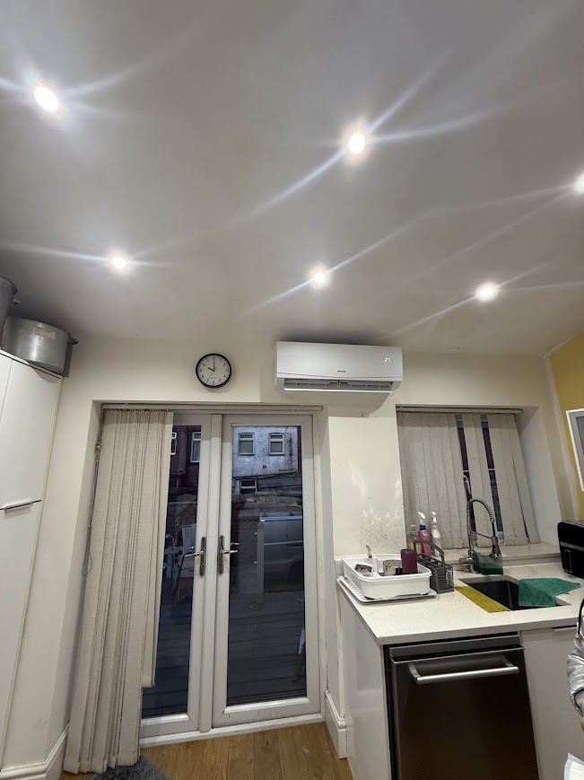 Sleek wall-mounted air conditioning unit installed in a modern new-build living room in Birmingham